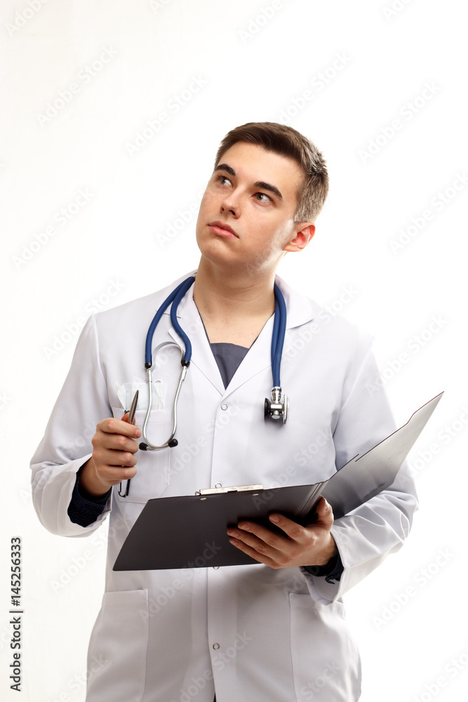 Young thinking doctor on a white background Young thinking doctor on a white background