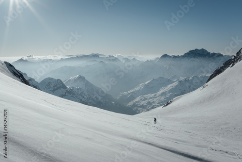 Mountaineer going up Vignemale's glacier at sunrise