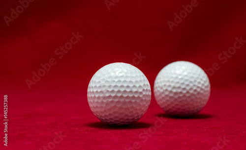 Two golf ball and red flannel background