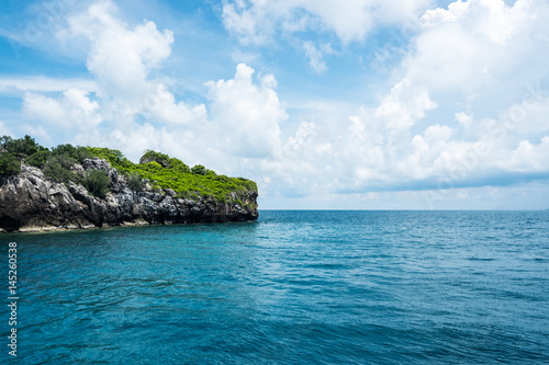 Seascape and small island with blue sky