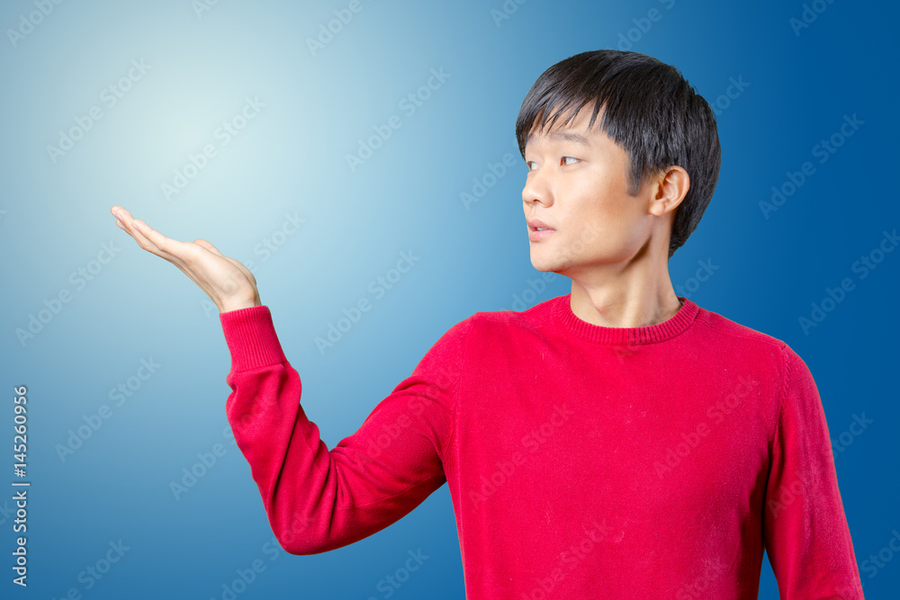 portrait of young asian man pointing portrait of young asian man pointing