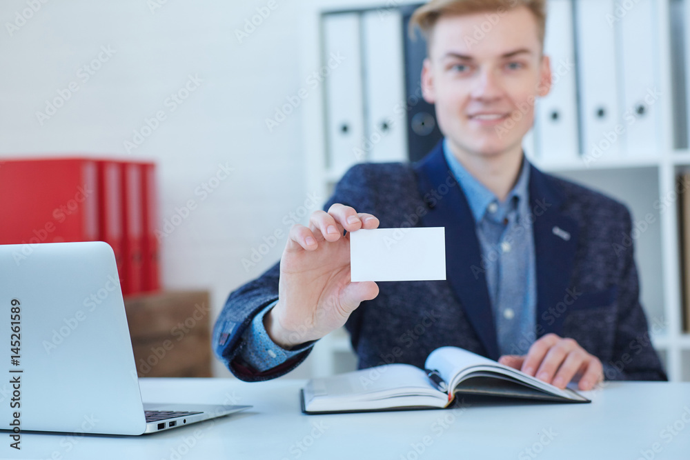Businessman in suit and hand holding blank calling card. Male hand showing white visiting card in camera closeup. Partners contact information exchange concept. Introducing gesture at formal meeting Businessman in suit and hand holding blank calling card. Male hand showing white visiting card in camera closeup. Partners contact information exchange concept. Introducing gesture at formal meeting
