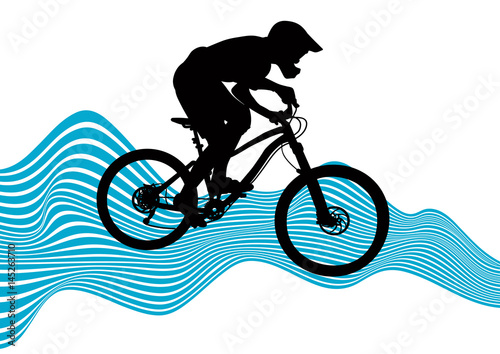 Silhouette of a biker descending on a mountain bike on a slope