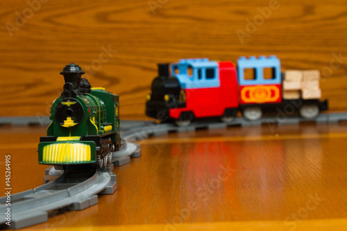 Fototapeta Naklejka Na Ścianę i Meble -  Two toy trains on the gray Rails