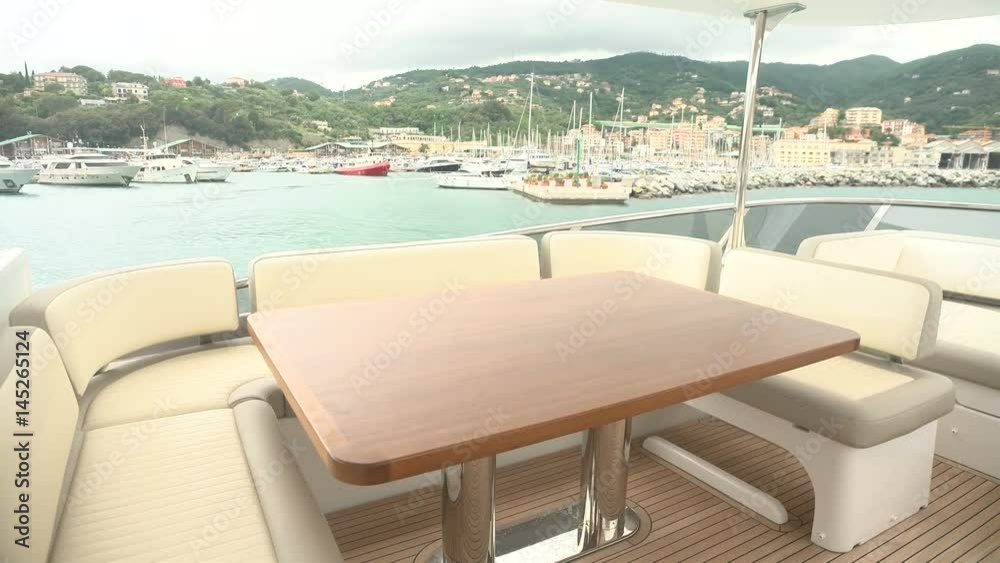 Wooden table and sofas on upper deck of a luxury yacht. Wooden table and sofas on upper deck of a luxury yacht.