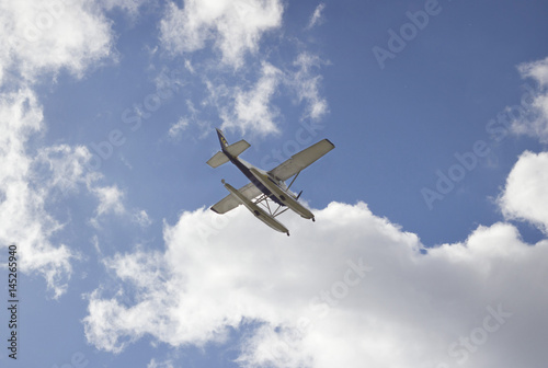 The plane on a background of blue sky and clouds