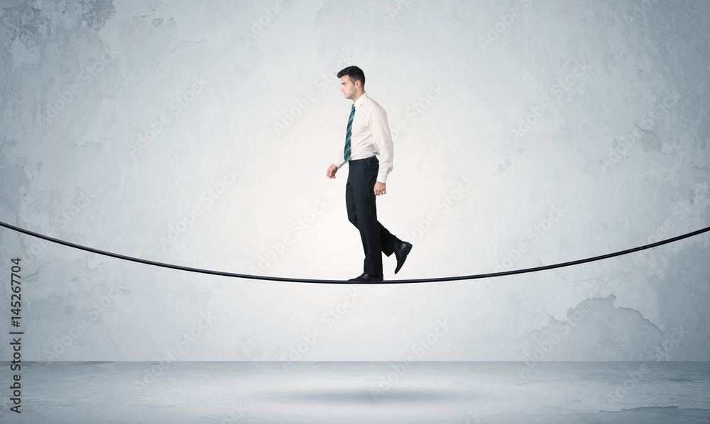 Sales guy balancing on tight rope Sales guy balancing on tight rope