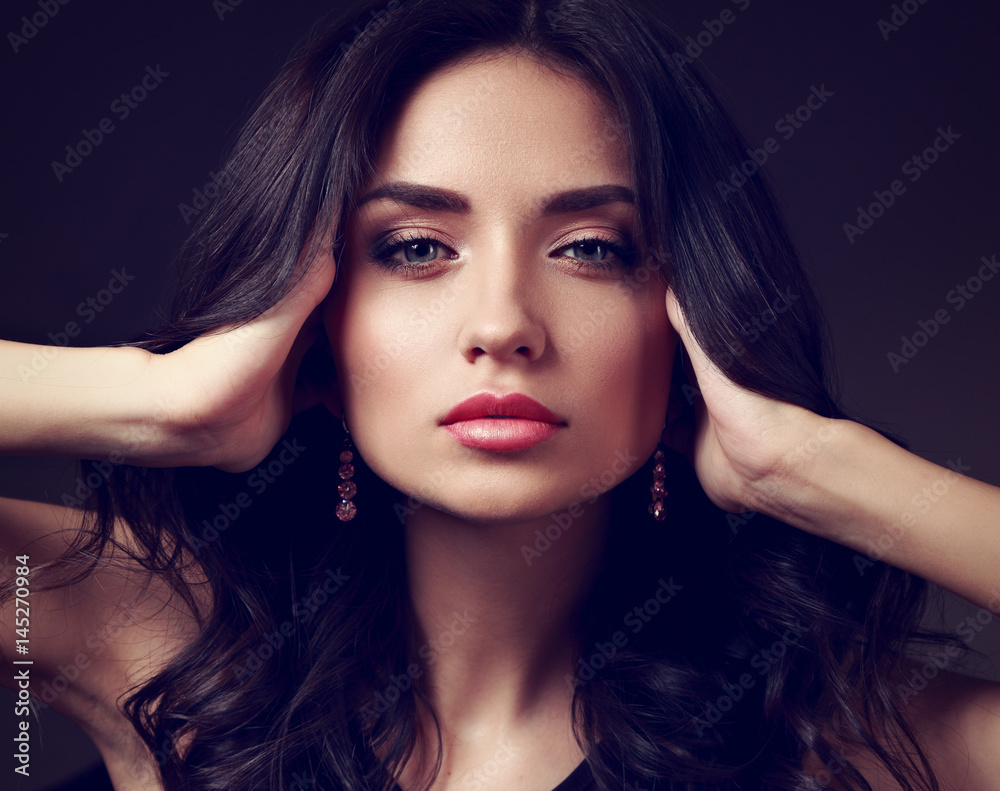 Fototapeta premium Beautiful makeup woman with pink lipstick and long curly hair looking calm. Closeup fashion portrait. Toned art