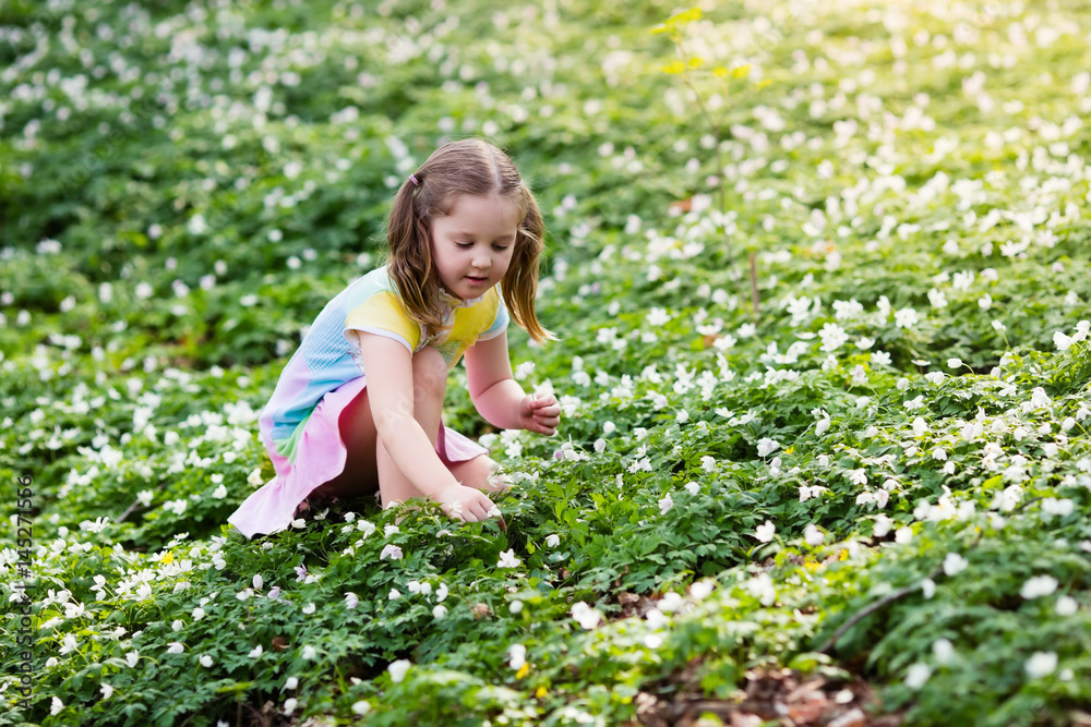Child in spring park with flowers Child in spring park with flowers