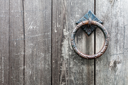 The old door handle on a wooden door