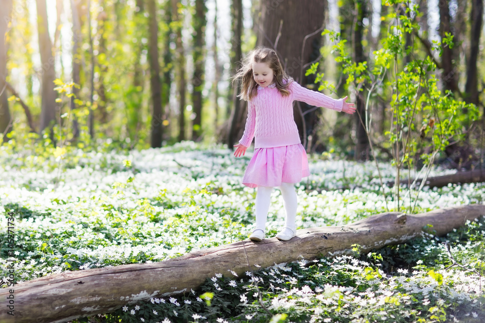 Child in spring park with flowers Child in spring park with flowers
