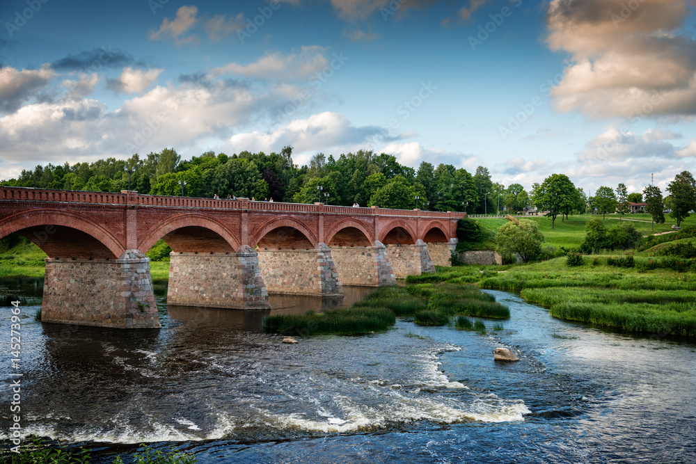 Old bridge with arches over the river.