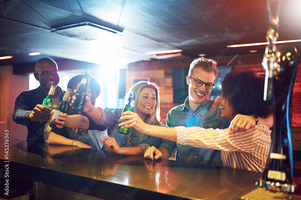 Friends gesturing cheers with beer at tavern Friends gesturing cheers with beer at tavern