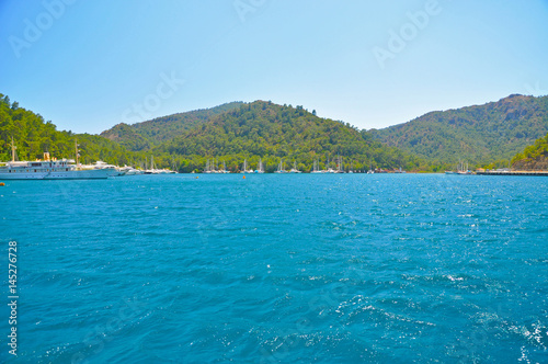 Fototapeta Naklejka Na Ścianę i Meble -  Blue Mediterranean sea with mountains and yachts