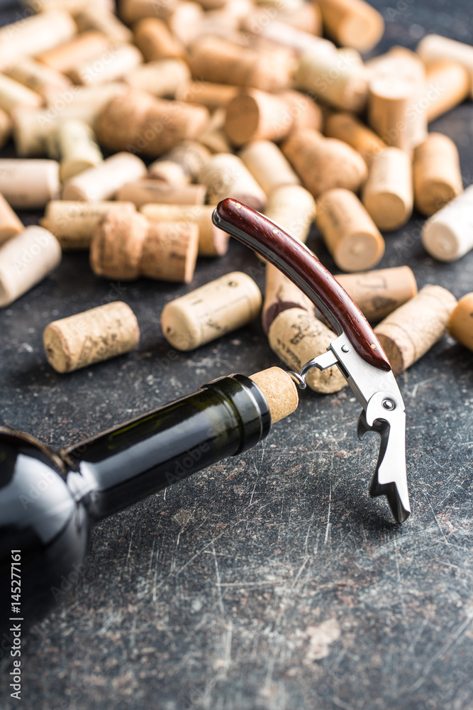 Bottle of wine with corkscrew.