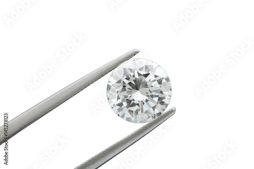 loose brilliant round diamonds is being held by tweezers on white background © Manutsawee