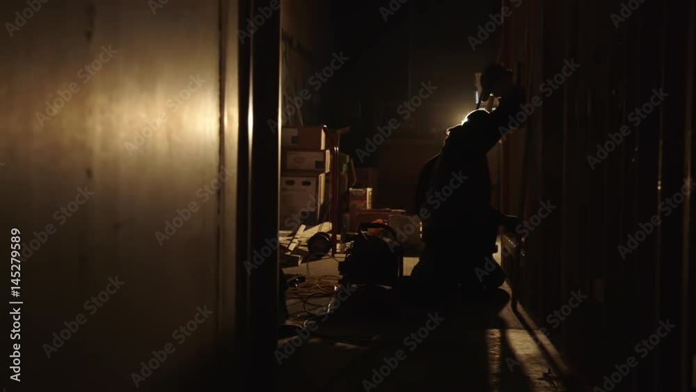 Carpenters Working Together in Dimly Lit Building