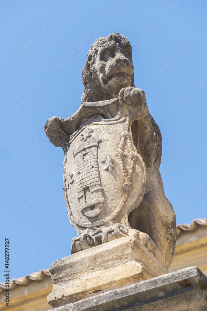 Stone lion on the facade Hospital de Santiago, Ubeda, Jaen, Spain
