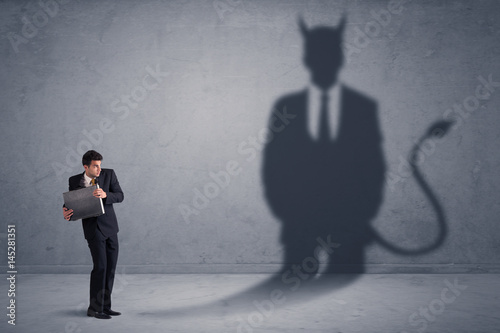Obraz na plátne Business man looking at his own devil demon shadow concept