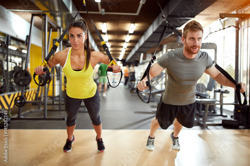 Couple on body training in gym