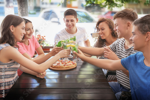 Happy friends eating pizza ...