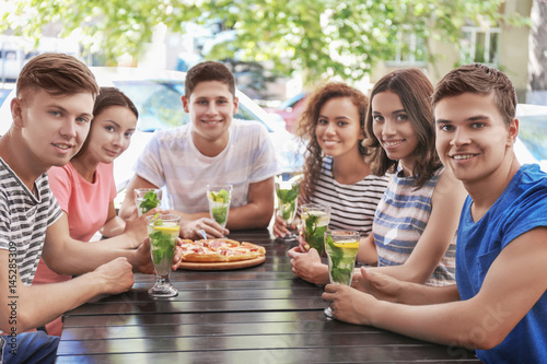 Happy friends eating pizza ...