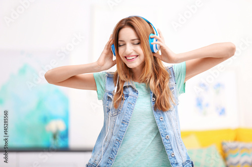 Beautiful young woman liste...
