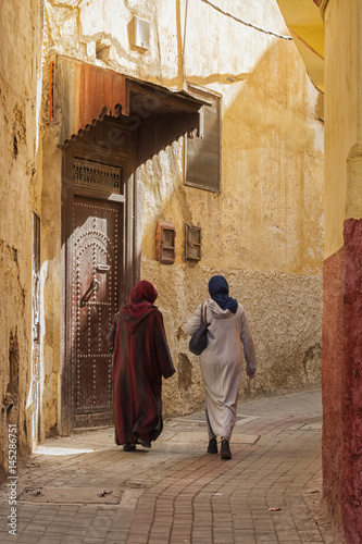 MEKNES, MOROCCO - FEBRUARY 18, 2017: Unidentified women walking in the street of Meknes, Morocco. Meknes is one of the four Imperial cities of Morocco.