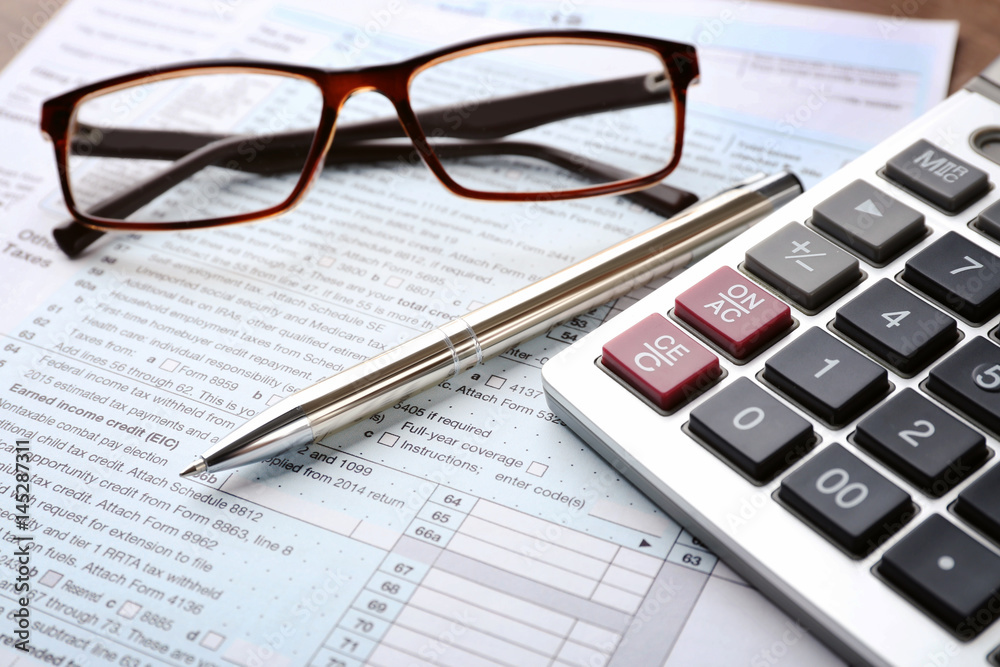 Calculator with documents and glasses on table. Tax concept Calculator with documents and glasses on table. Tax concept