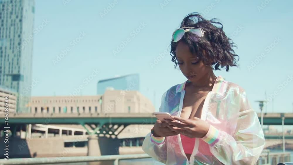 Young black woman looking at cellphone Young black woman looking at cellphone