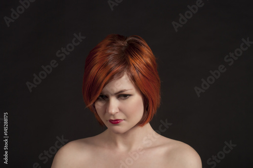 Portrait of a smiling girl on a dark background.