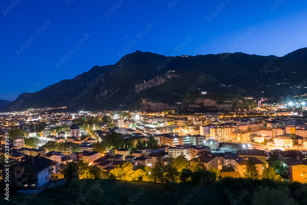 Smart and sustainable city, beautiful city at night in the valley. Trento, Italy