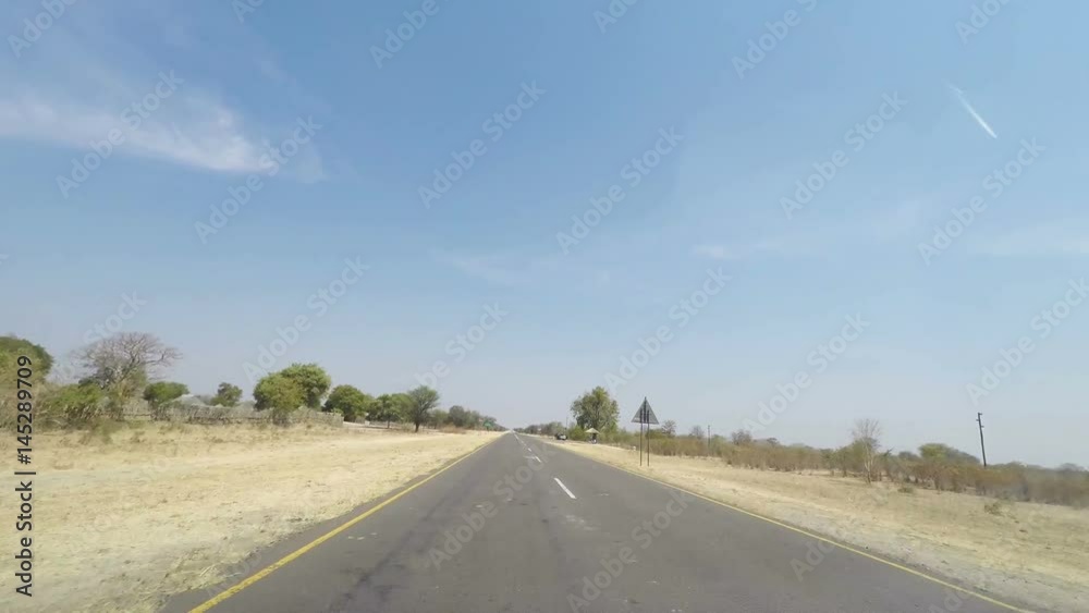 Driving on road in the Caprivi Strip, the most populated region in Namibia, Africa. View from car mounted camera. Driving on road in the Caprivi Strip, the most populated region in Namibia, Africa. View from car mounted camera.