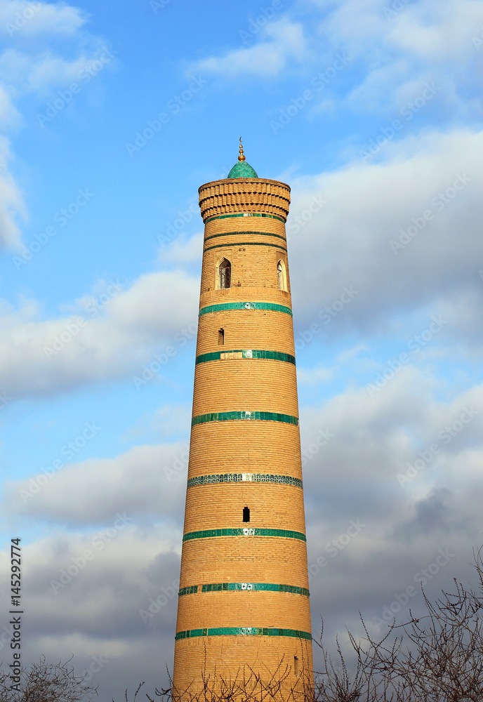 Minaret on the background of a cloudy sky