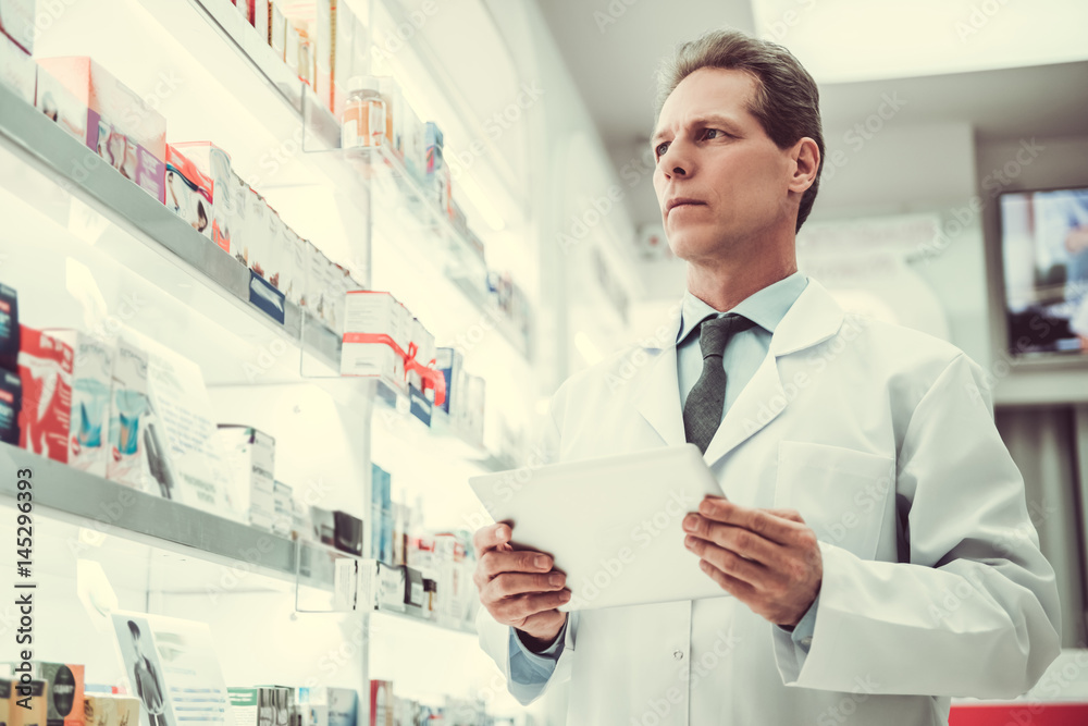 Handsome pharmacist working Handsome pharmacist working