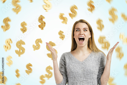 Happy blond woman and dollar signs photo