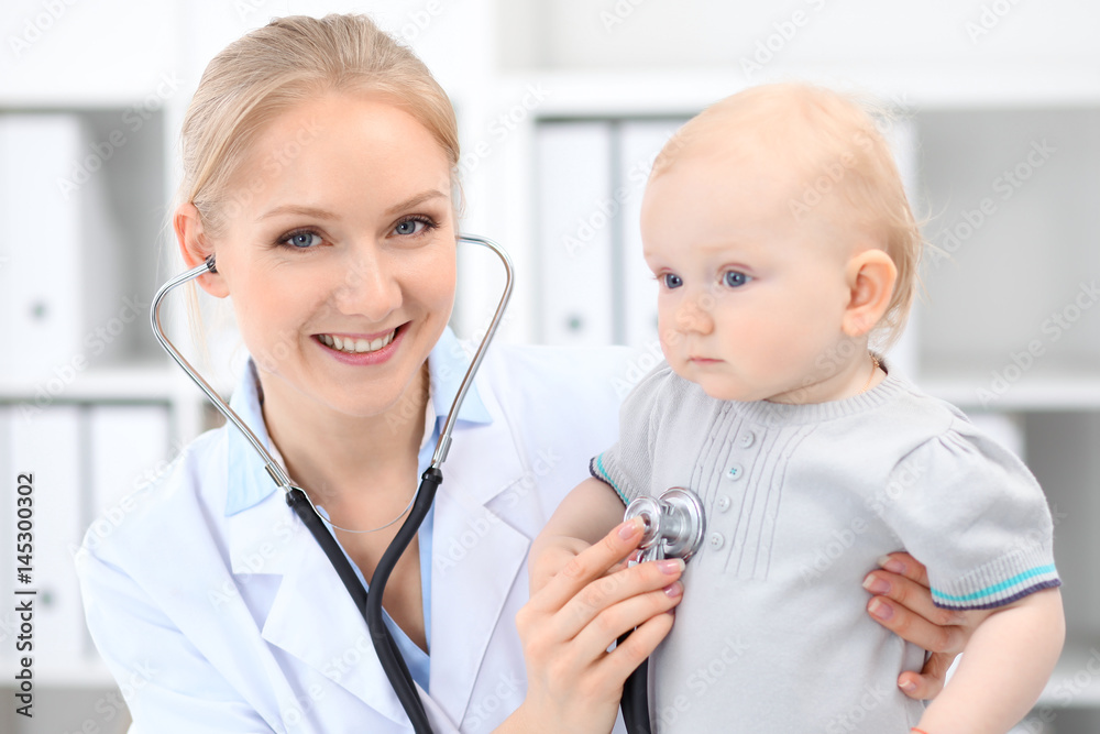 Pediatrician is taking care of baby in hospital. Little girl is being examine by doctor with stethoscope. Health care, insurance and help concept.