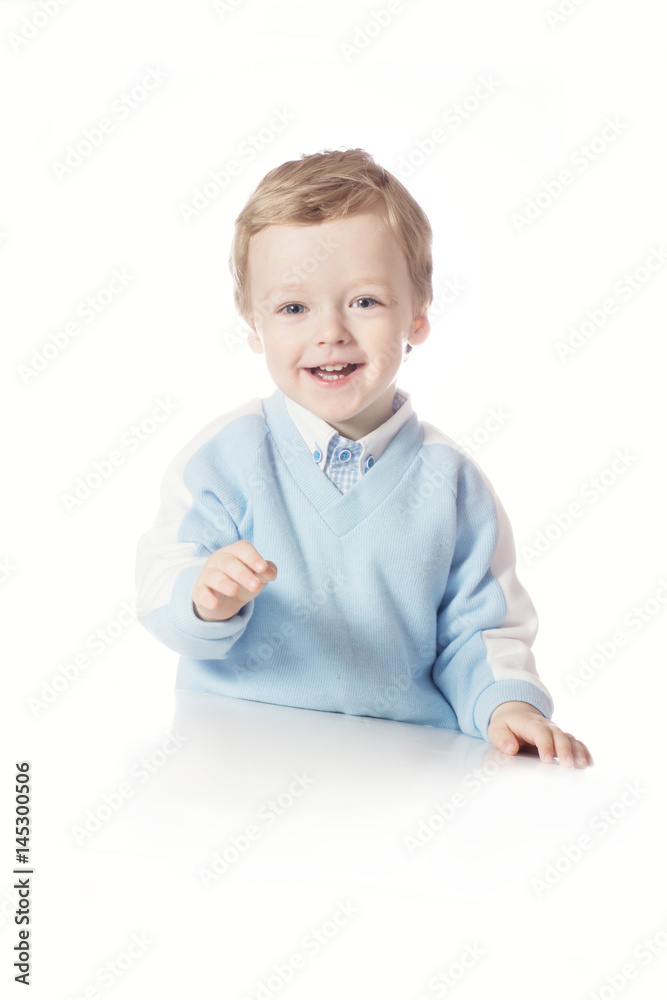 The little boy laughs cheerfully. A boy is holding a white background in his hands. A boy is isolated on a white background The little boy laughs cheerfully. A boy is holding a white background in his hands. A boy is isolated on a white background