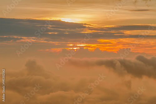 Shot from an airplane. Evening sunset. Background of clouds, sun