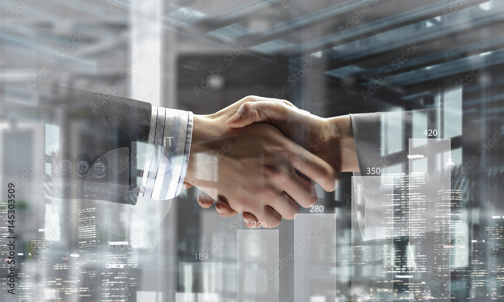 Partners shaking hands as symbol of deal . Mixed media Partners shaking hands as symbol of deal . Mixed media