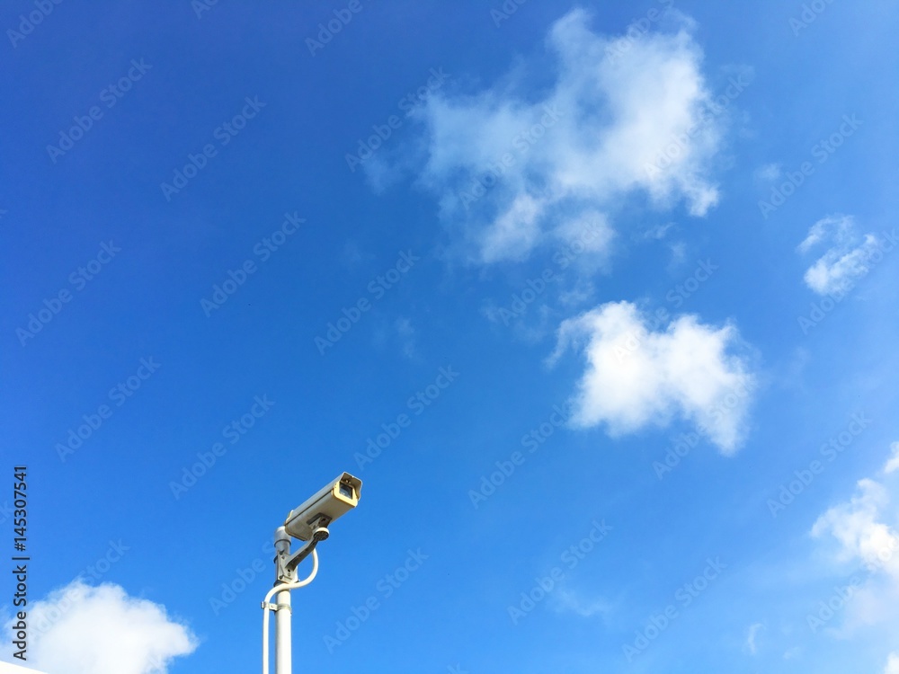CCTV security camera on the beautiful blue sky background