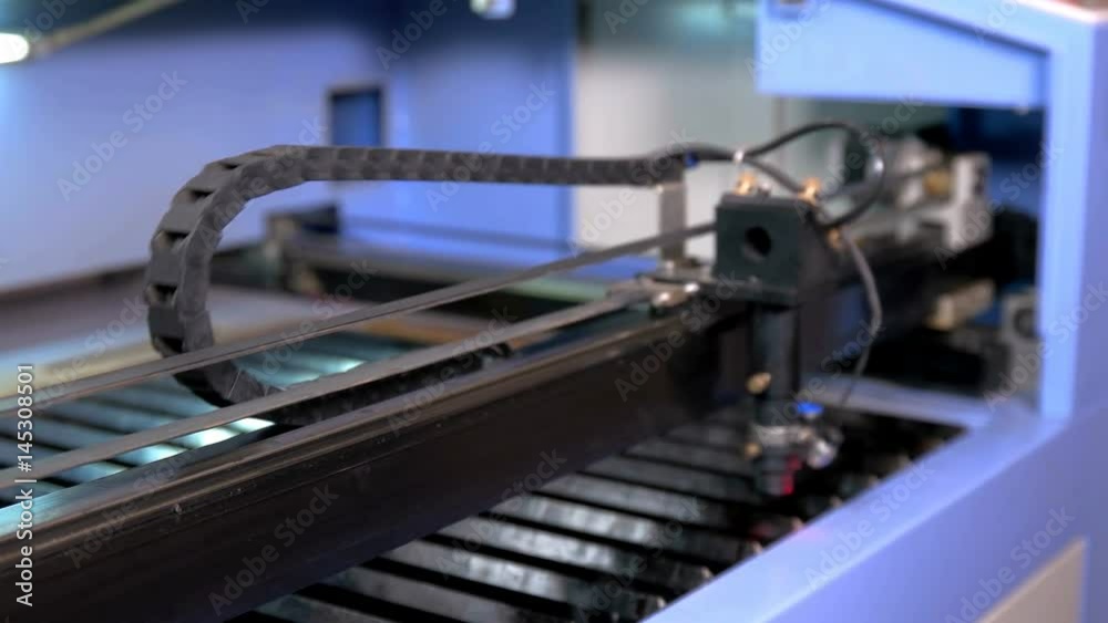 The carriage on the laser machine moves during operation The carriage on the laser machine moves during operation