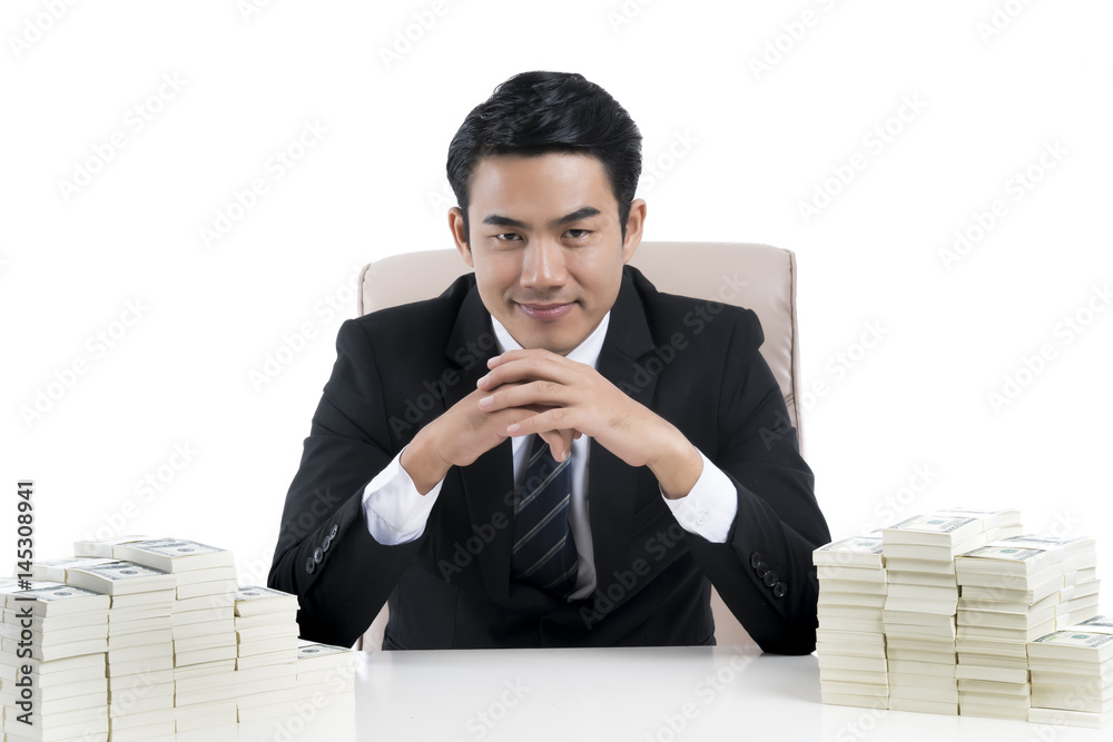 Happy Young businessman clasped hands and large pile of money on table. Happy Young businessman clasped hands and large pile of money on table.