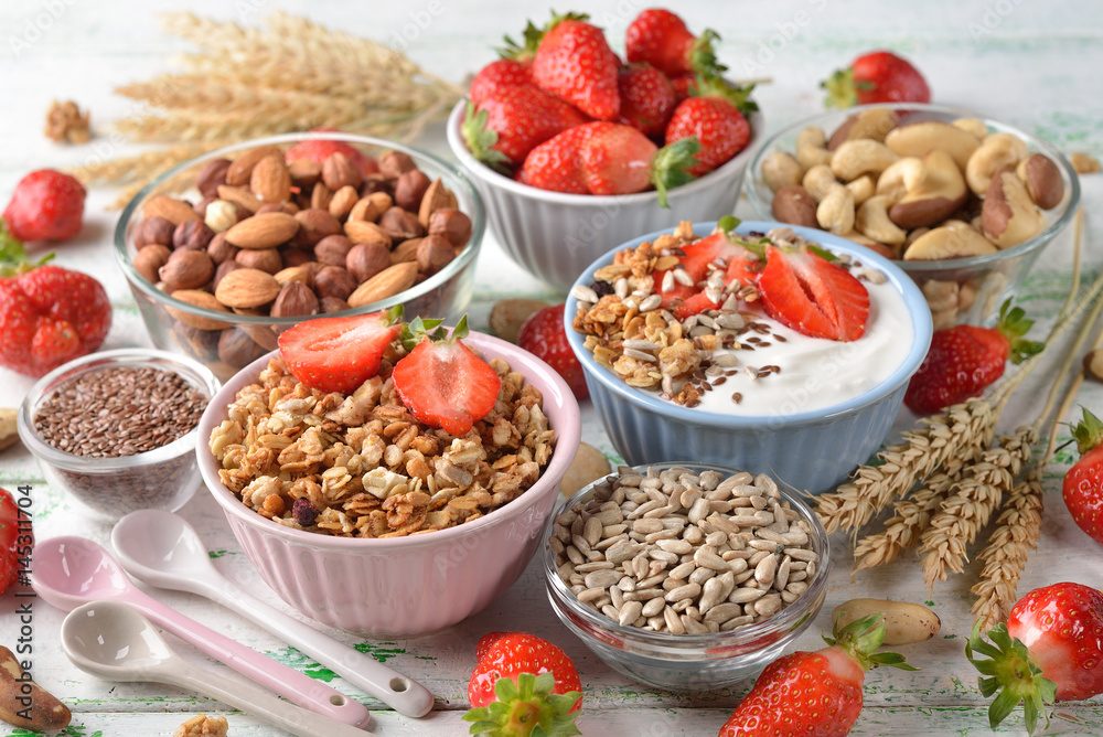Muesli, nuts, yogurt and cereals on a white background Muesli, nuts, yogurt and cereals on a white background