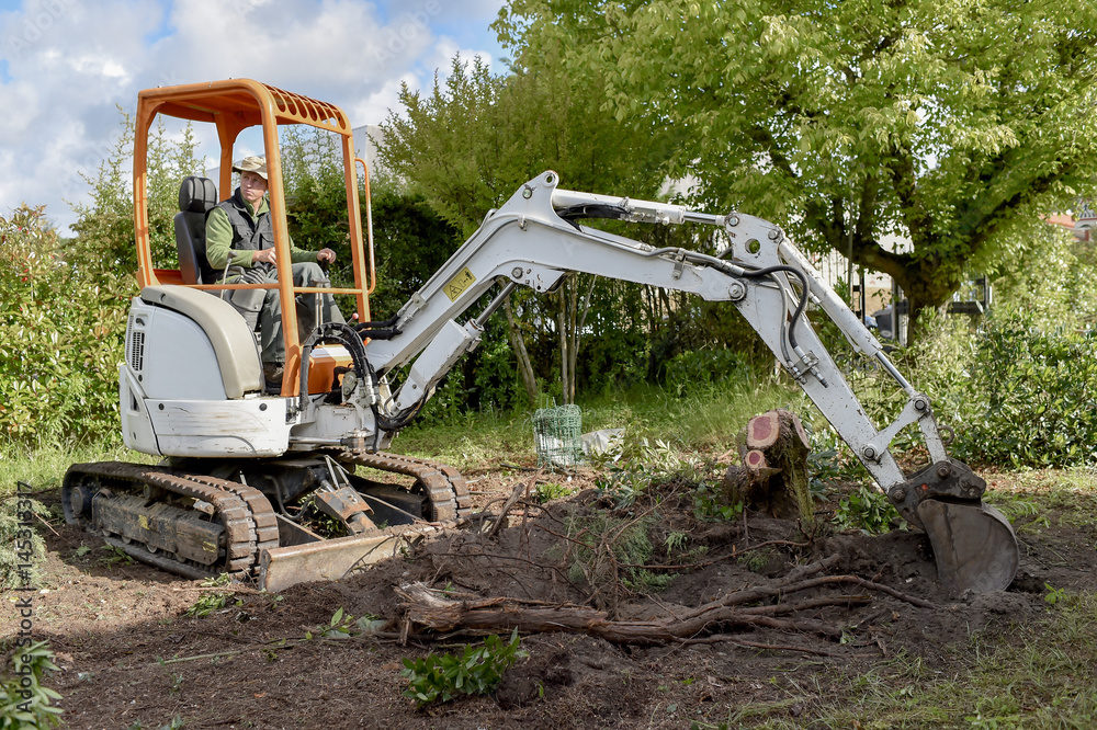 Man using a digger in the garden Man using a digger in the garden