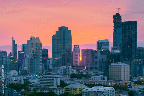 Bangkok business district city tower skyline while sunset.