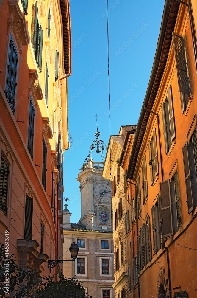 The narrow street ended with a church. The tower is crowned with a dome of unusual shape. Rome. Italy