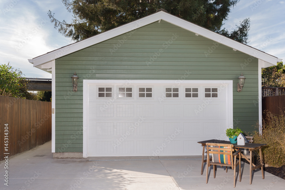 Naklejka premium Green house exterior with white garage door