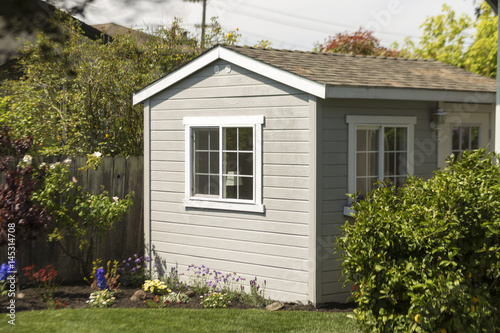 Side shot of a cozy wooden house and garden