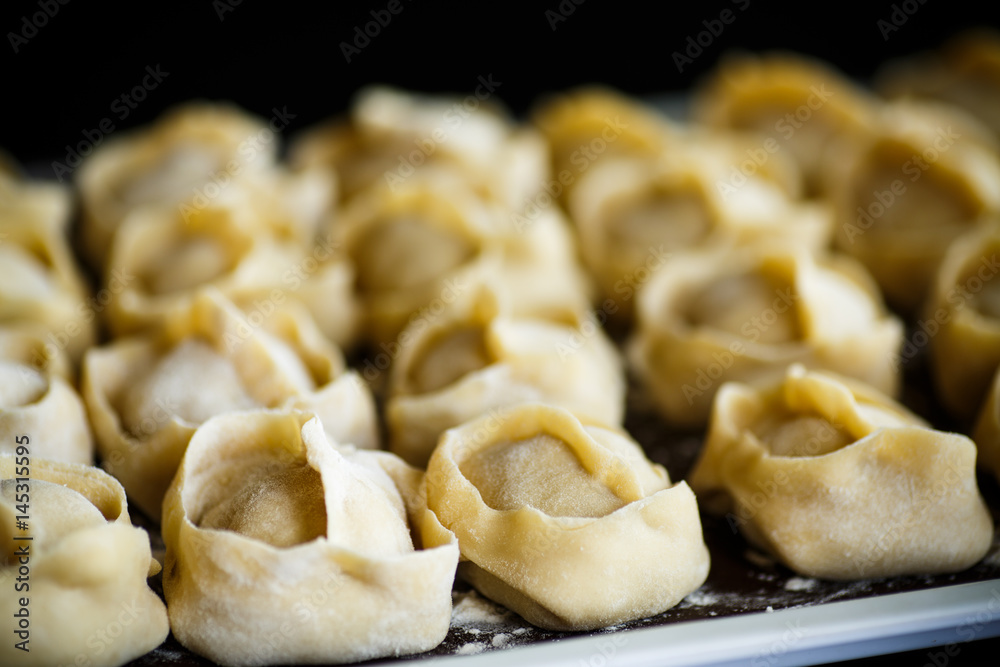 traditional raw manti with meat inside traditional raw manti with meat inside